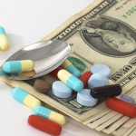 assorted medicine with money with spoon
