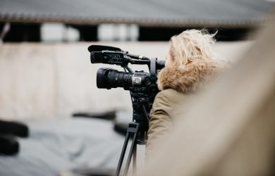 black camera on tripod in tilt shift lens