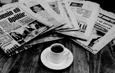 White Ceramic Mug on White Newspaper