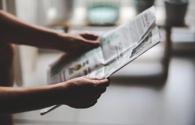 Person reading newspaper
