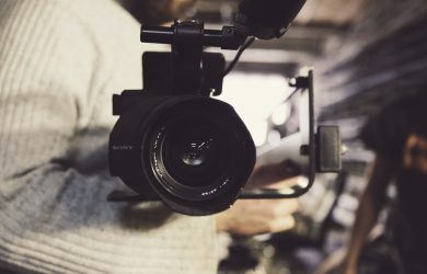 closeup photo of person carrying professional video recorder