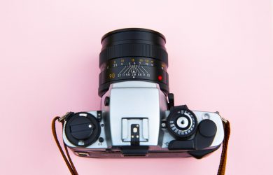 Black and Silver Camera on Brown Wooden Table