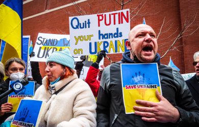 People Holding Anti-War Signs and Protesting in the Street