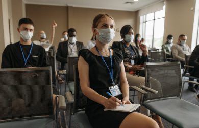 A Group of People Taking Notes in a Conference Room