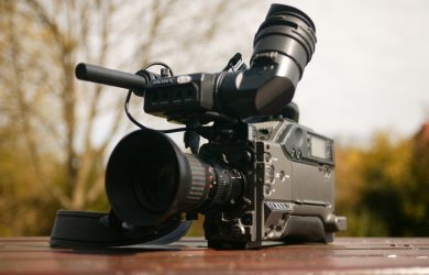 Black Video Camera on Brown Wooden Table