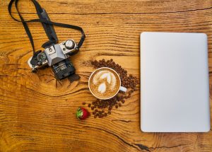Latte Coffee And Camera On Wooden Surface