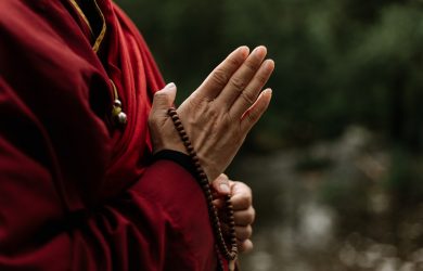 Hands Holding a Brown Prayer Beads