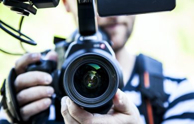 Person Holding Canon Dslr Camera Close-up Photo