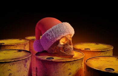 a human skull wearing a santa hat on top of barrels